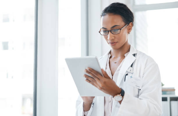 istock Shot of a young doctor using her digital tablet at work 1357522277