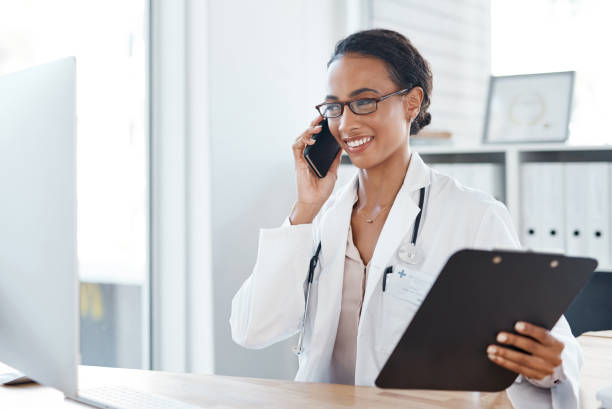 istock Shot of a doctor making a phone call using her smartphone 1357522292