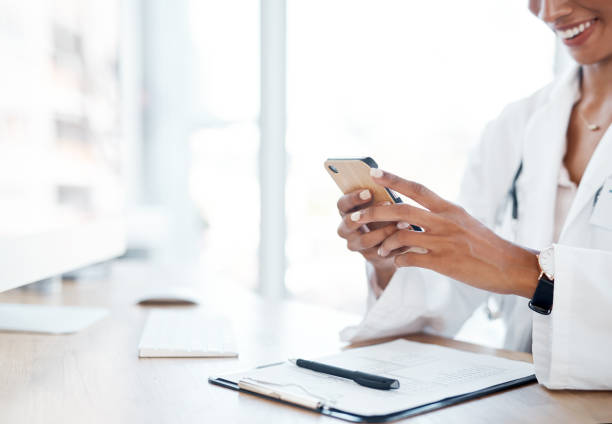 istock Shot of a female doctor using her smartphone to send a text 1357522302