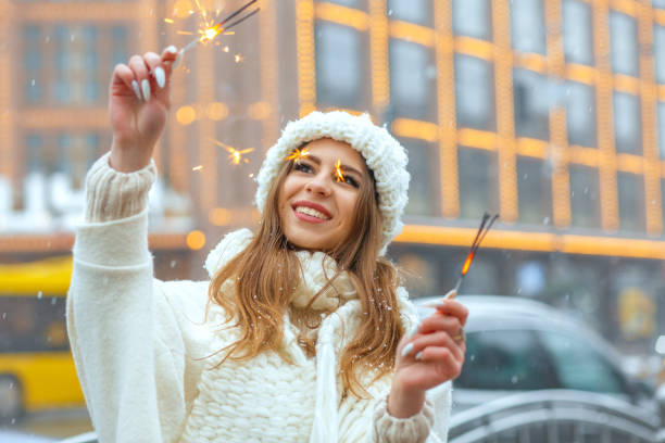 istock Merry woman having fun with sparklers in winter 1357522778
