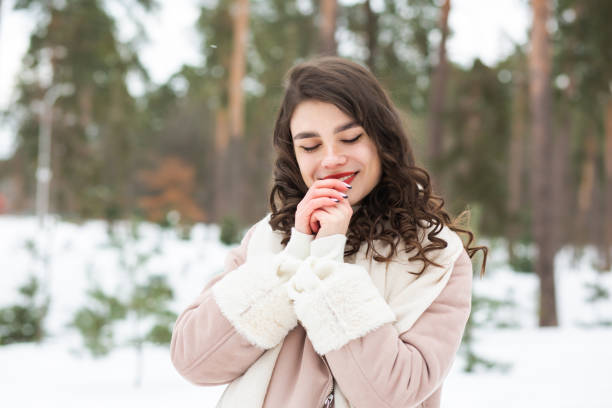 istock Joyful young lady walking at the winter forest 1357522793