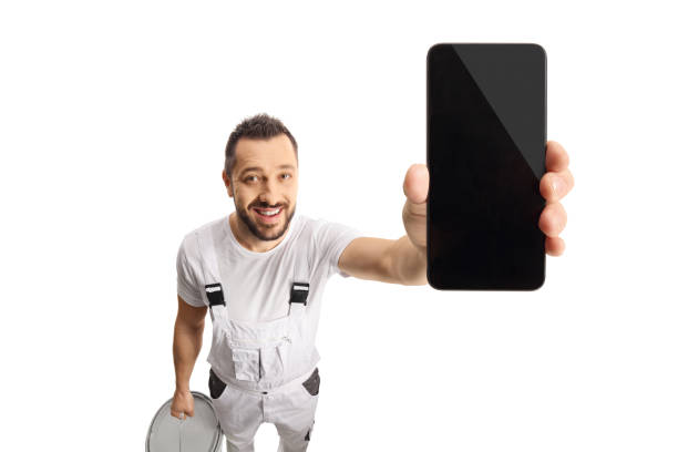 istock House painter holding a smartphone in front of camera 1357523022