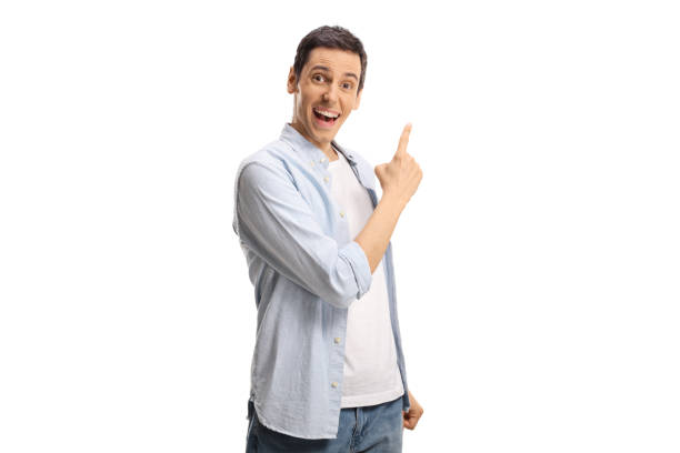 istock Happy young man pointing with finger 1357523059