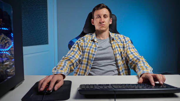 istock Woman gamer plays computer game with keyboard and mouse 1357523361