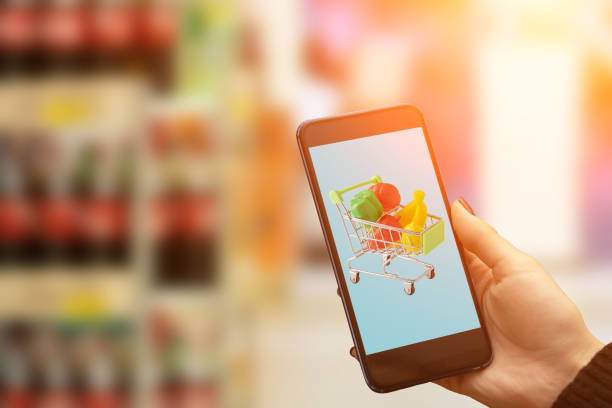 istock supermarket online on phone,trolley with products on device screen 1357523788