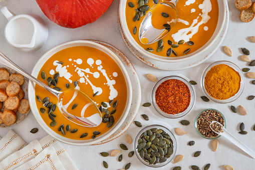 Close-up of a pumpkin soup with spices and pumpkin seeds