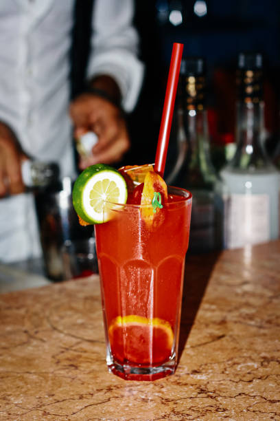 istock Red drink with strawberry lime ice. Bartendeer prepared cocktail with campari aperol gin 1357523867