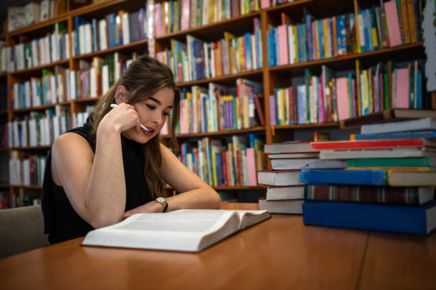 istock a young smart student is studying useful and interesting in a beautiful old library. 1357525852