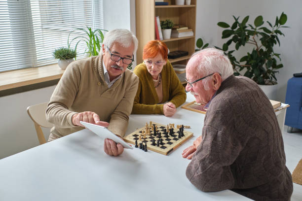 istock Senior people learning to play chess 1357525985