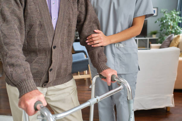istock Elderly person moving with the help of a walker 1357526012