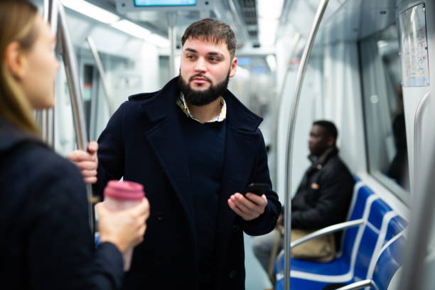 istock Young man talking with woman in subway 1357526200