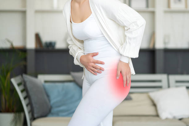 Hip pain, woman suffering from osteoarthritis at home stock photo