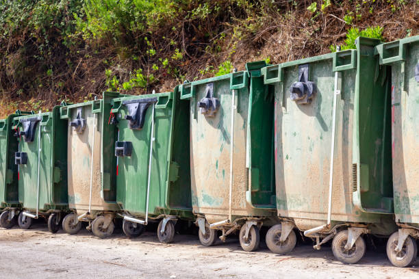 istock Trash or garbage cans standing in a row outdoors 1357528036