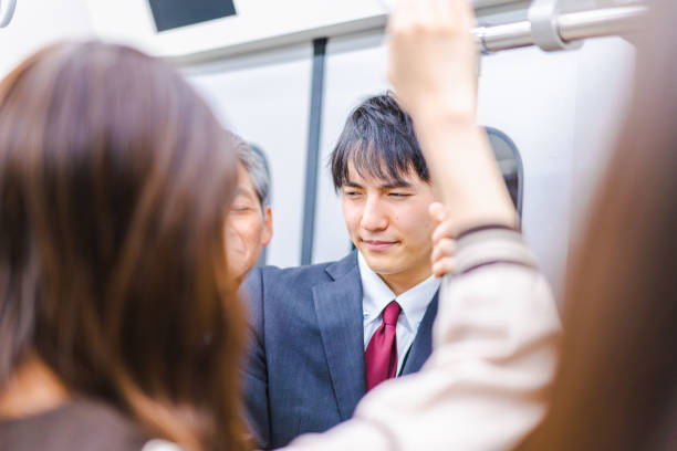 istock Business people commuting on crowded trains 1357528401