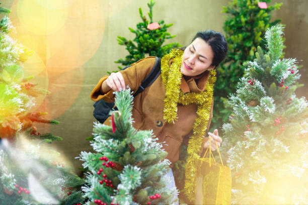 istock Woman choosing christmas tree 1357530311