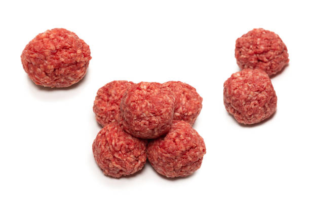 istock Raw meat balls isolated on white background. 1357530397