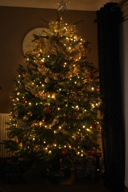 istock Christmas tree baubles, decorations, lights and tinsel close up 1357530604