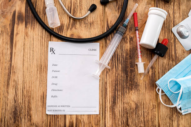 istock on a wooden table is a recipe, mask, stethoscope, pills, syringe 1357531014