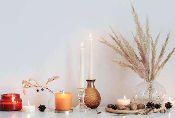 istock autumn home decorations with burning candles 1357531247