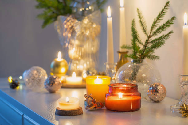 istock christmas decorations with burning candles in white room 1357531267