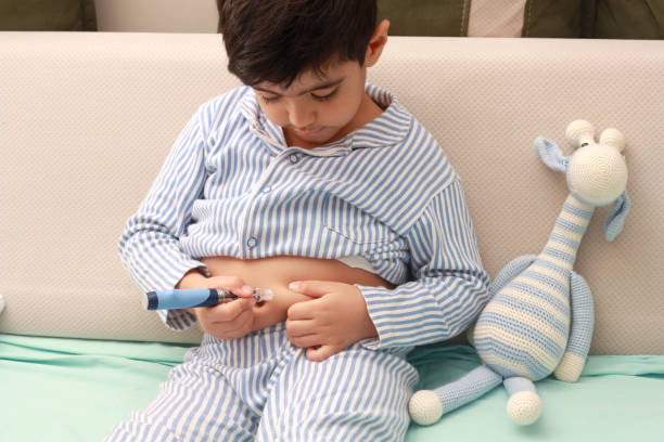 insulin, diabetes, diabetic child. Cute boy taking an insulin shot at stomach. insulin stock pictures, royalty-free photos & images