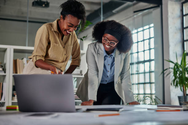 istock Two african businesswomen working in office and using technology 1357532137