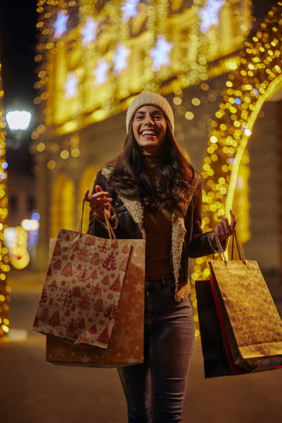 istock Young woman shopping for Christmas 1357532165