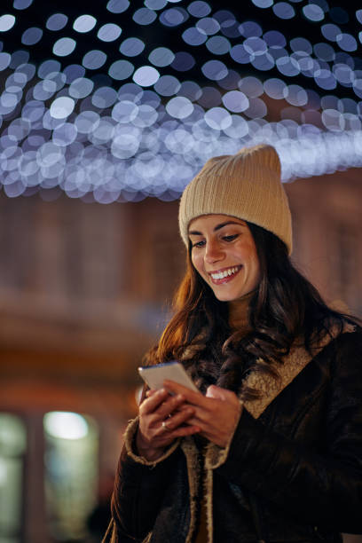 istock Woman on Christmas time using the phone 1357532179