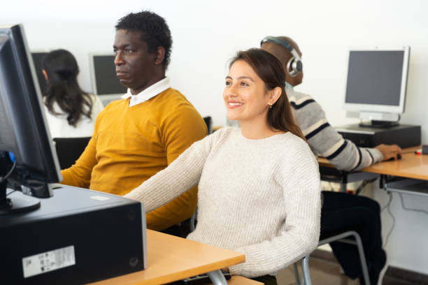 istock Young adult woman studying in computer class 1357532485