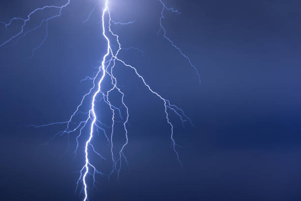 istock Lightning or thunderbolt in night storm in blue light 1357537239