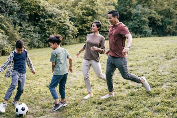 istock Hispanic family playing soccer 1357539913