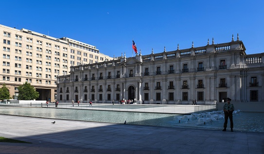 Santiago de Chile, Chile, November 29, 2018: Viec of the president palace La Moneda on the Plaza de la Ciudadanía. It is a neoclassical palace completed in 1805. At the coup d'état of 11 September 1973, La Moneda was bombed by a military air force and President Salvador Allende shot himself in the encircled palace.