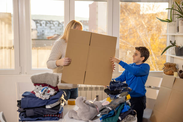 istock Mother and son preparing donation box 1357544874