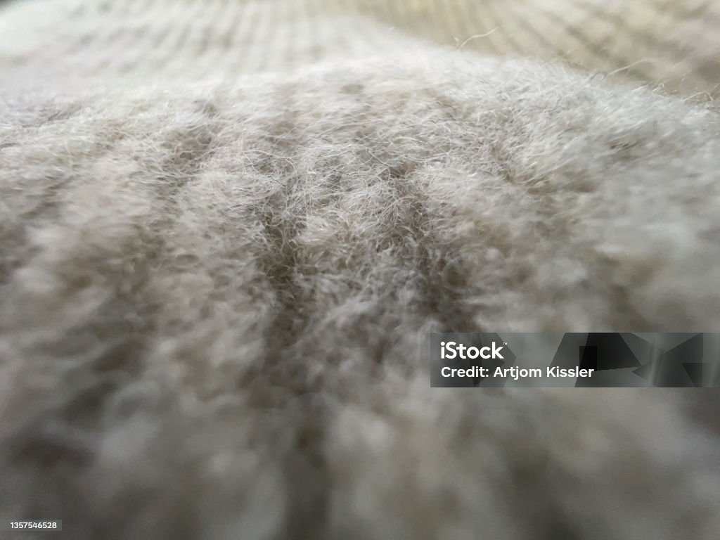 A macro shot of the fine white fabric. Wool Stock Photo