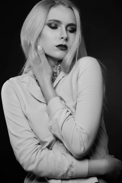 istock Glamorous blond model posing with foil on her neck 1357546939