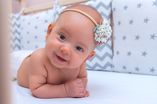 Portrait of a newborn girl with a flower crown on her head