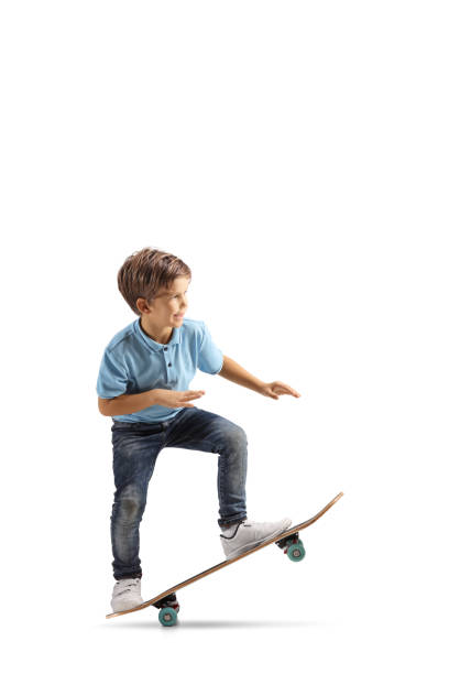 istock Little boy performing a trick with a skateboard 1357548436