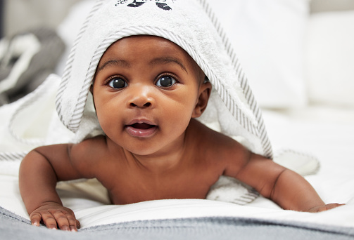 Shot of an adorable baby boy wearing a hoody towel
