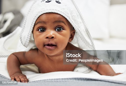 istock Shot of an adorable baby boy wearing a hoody towel 1357549139