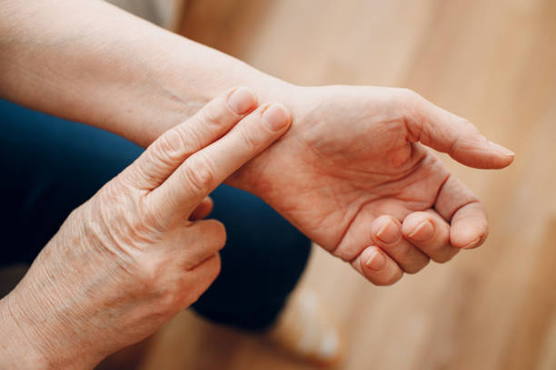 Female old hand measuring her own arm pulse. Elderly woman heart health Female old hand measure check arm pulse. Elderly woman heart health. taking pulse stock pictures, royalty-free photos & images