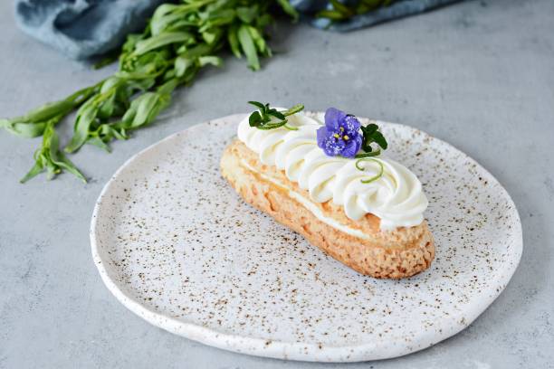 French eclair with fruit and chocolate coconut and gentle mousse. Delicious dessert. Cake in the glaze. French eclair with fruit and chocolate coconut and gentle mousse. Delicious dessert. Cake in the glaze. Confectionery product. tarragon horizontal color image photography stock pictures, royalty-free photos & images