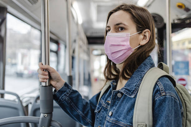 istock Woman with a protective face mask in a bus 1357550165