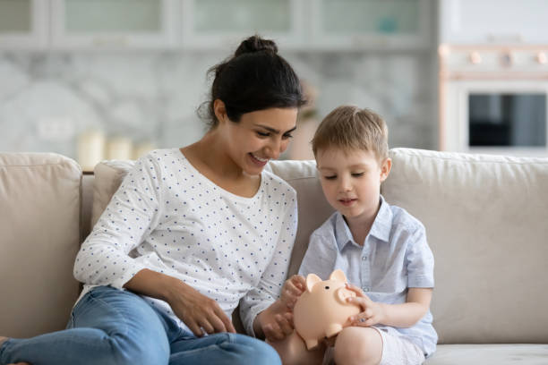istock Happy       mom teaching little son to save money 1357550408