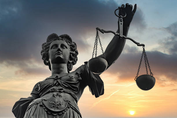 Symbol of Justizia figure Symbol of Justizia figure in Frankfurt with dramatic sunrise background paragraph photos stock pictures, royalty-free photos & images