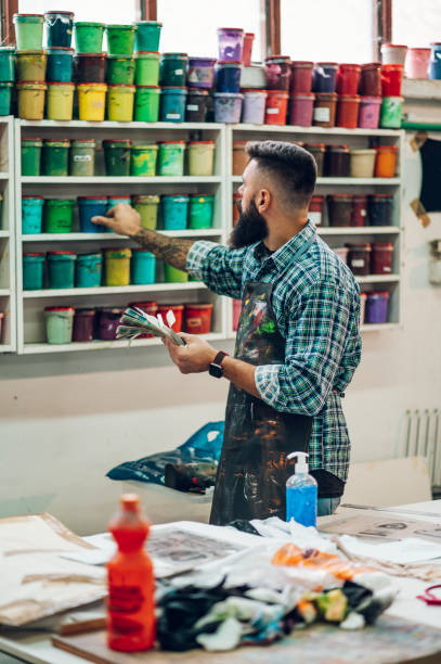 istock Male worker mixing colors for screen printing in a workshop 1357551735