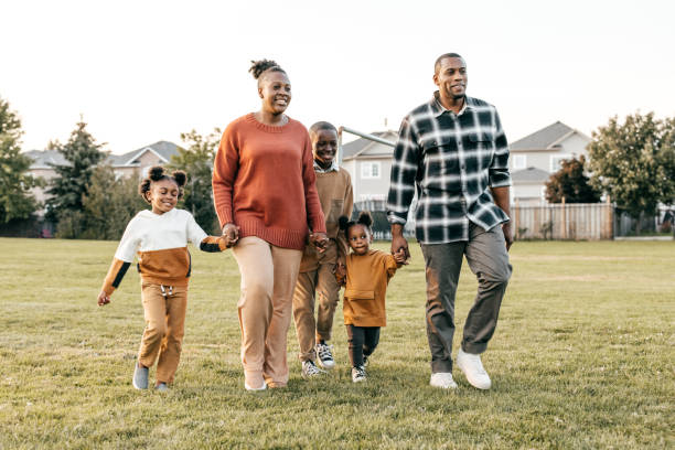 istock Two parents walking with 3 kids 1357554922
