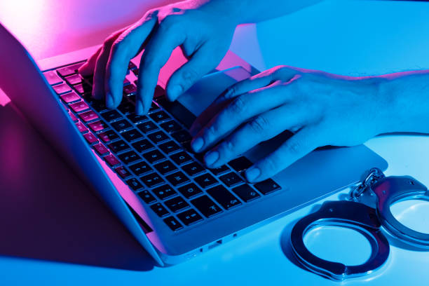 istock Cyber crime concept with man in handcuffs 1357555916
