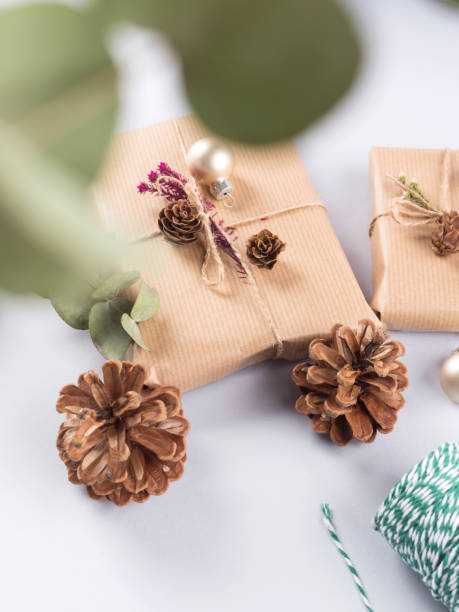 istock Christmas festive still life with wrapped presents, pine cones 1357556169