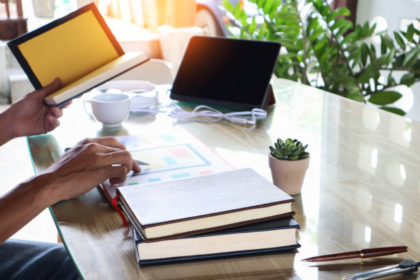 istock businessman hand working use statistics on the graph to study online trading investment profits.concept 1357556285