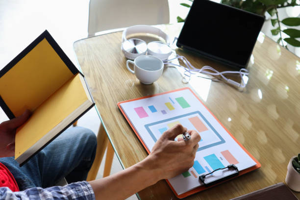 istock businessman hand working use statistics on the graph to study online trading investment profits.concept 1357556295